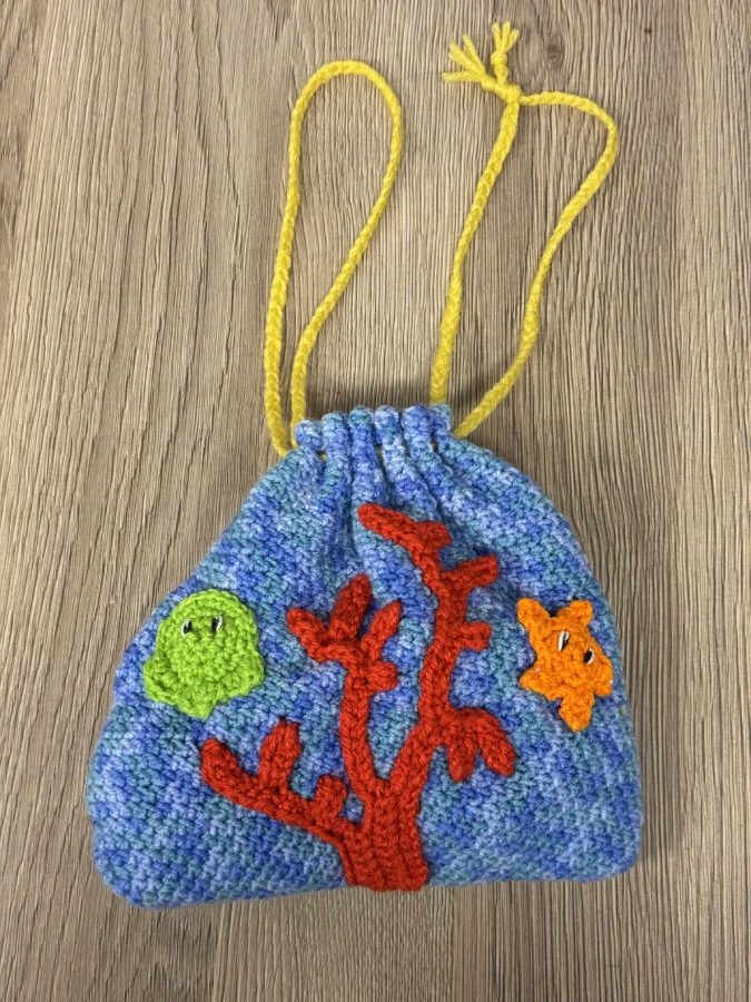 Pieuvre au crochet : pourquoi ce motif fait main a autant de succès 7 pochette en crochet fait main avec pieuvre et étoile, thème fond marin